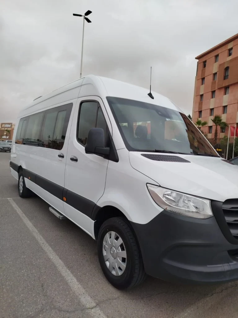 White Mercedes Sprinter minivan parked in a Marrakech parking lot, used for private day trip transport